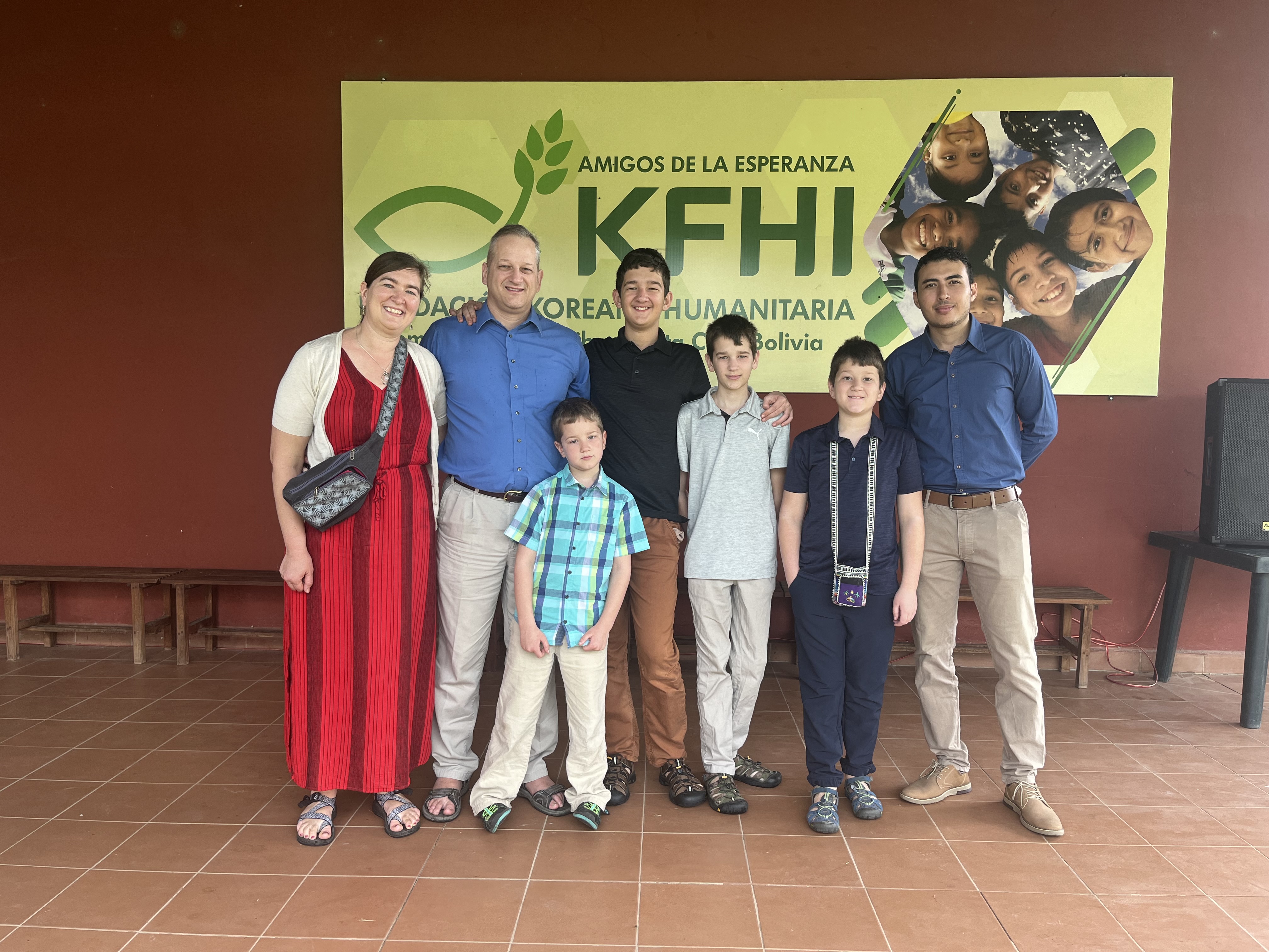 group of adults and children standing and smiling at camera