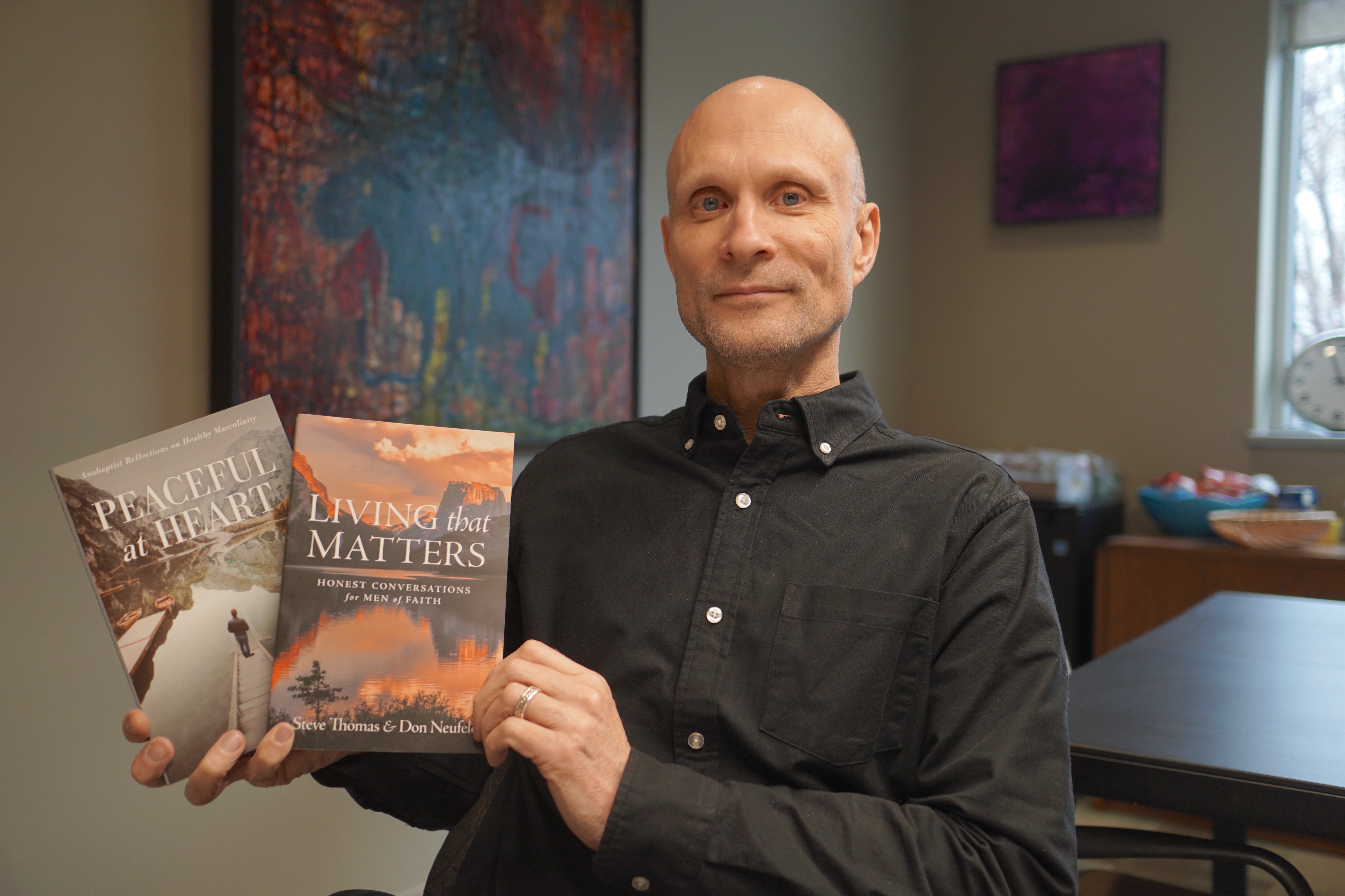 Man holding two books