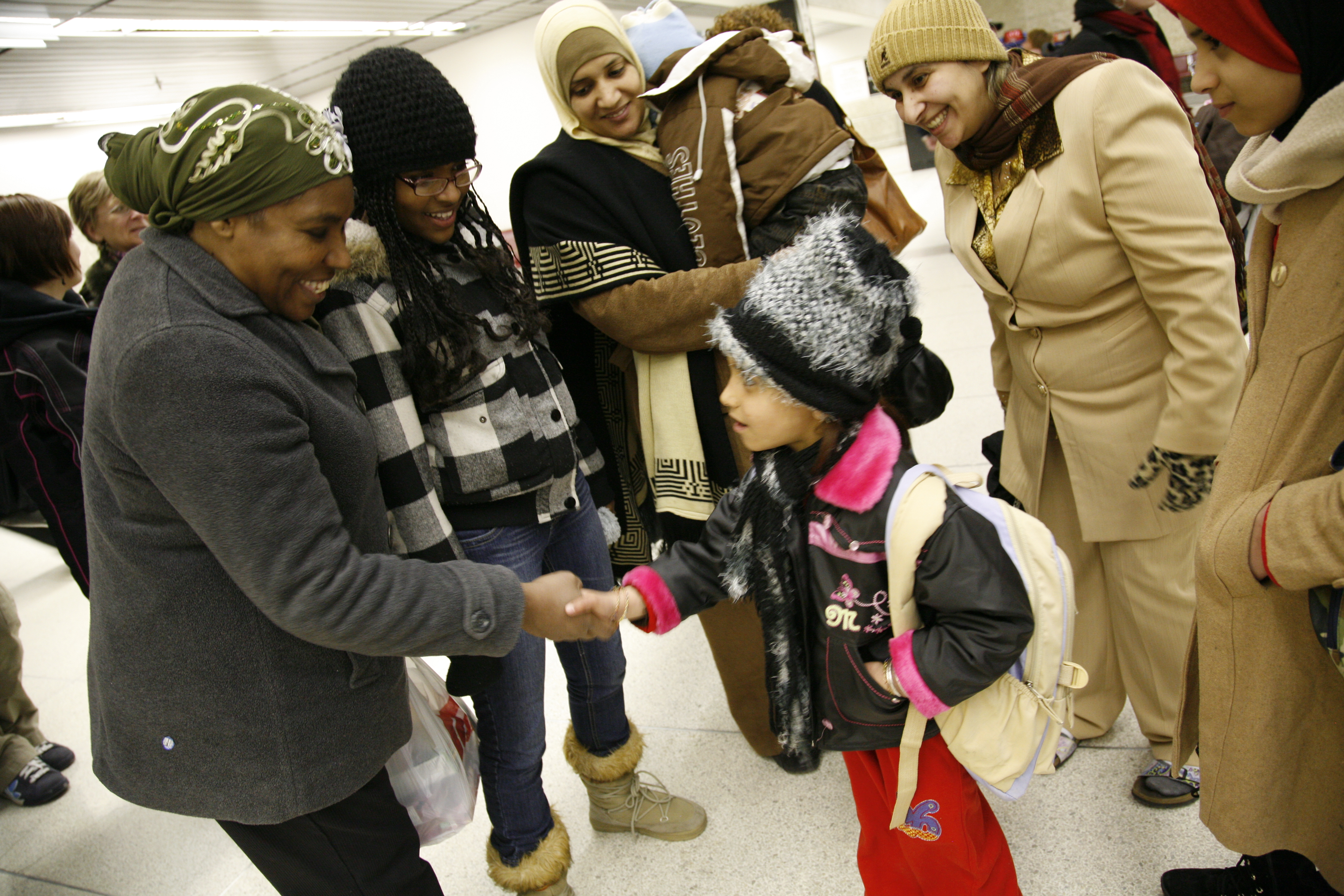 Family welcomes another family at the airport
