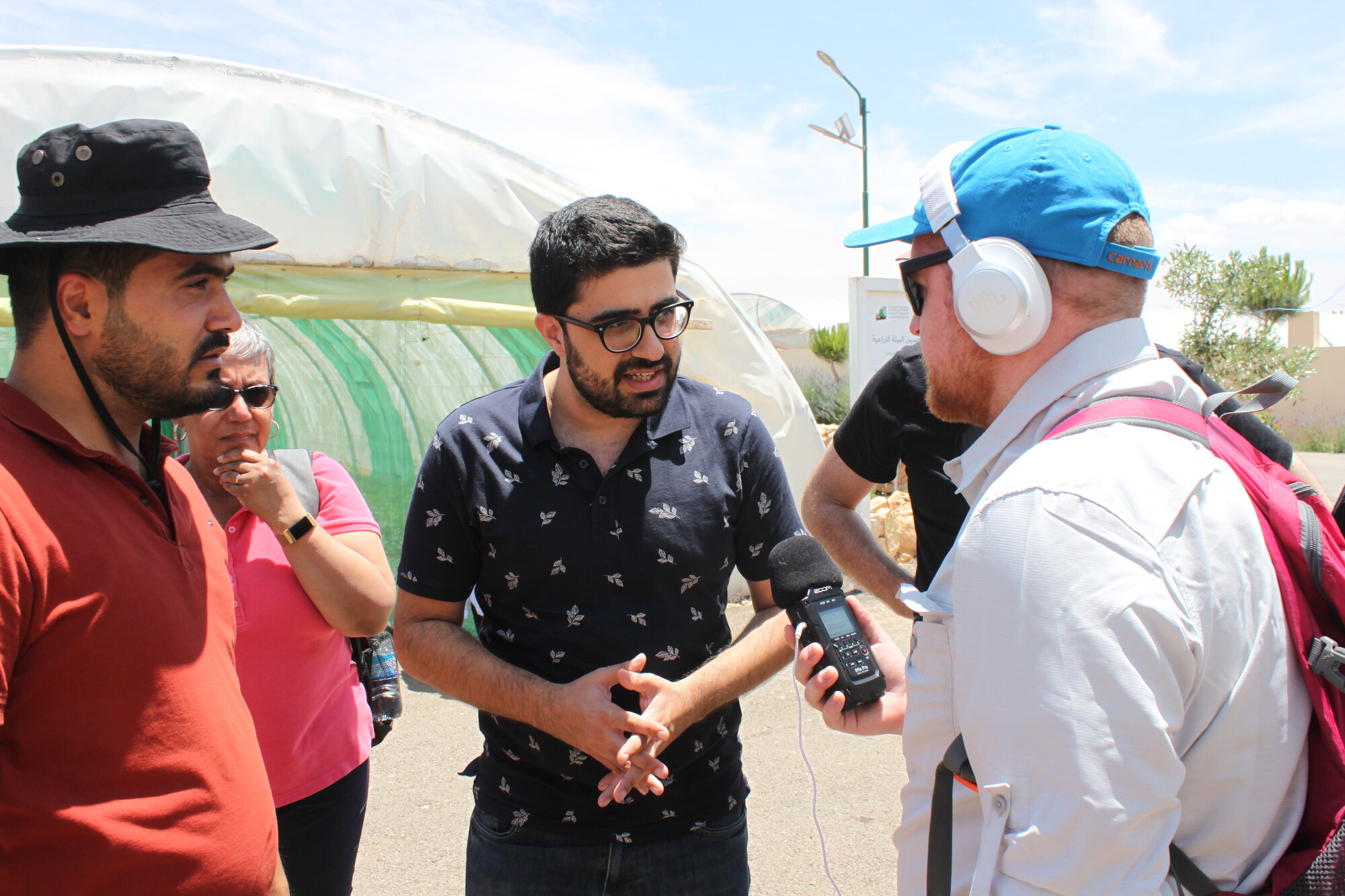 Staff person interviews a group of program participants.