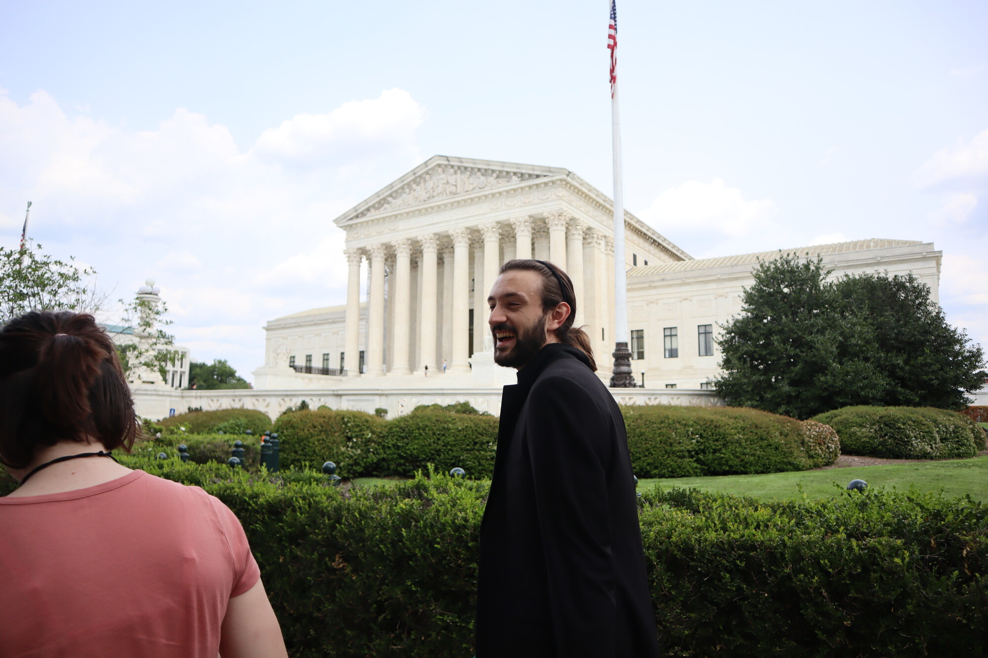 A man and woman walking in front of the Russell Senate Office Building
