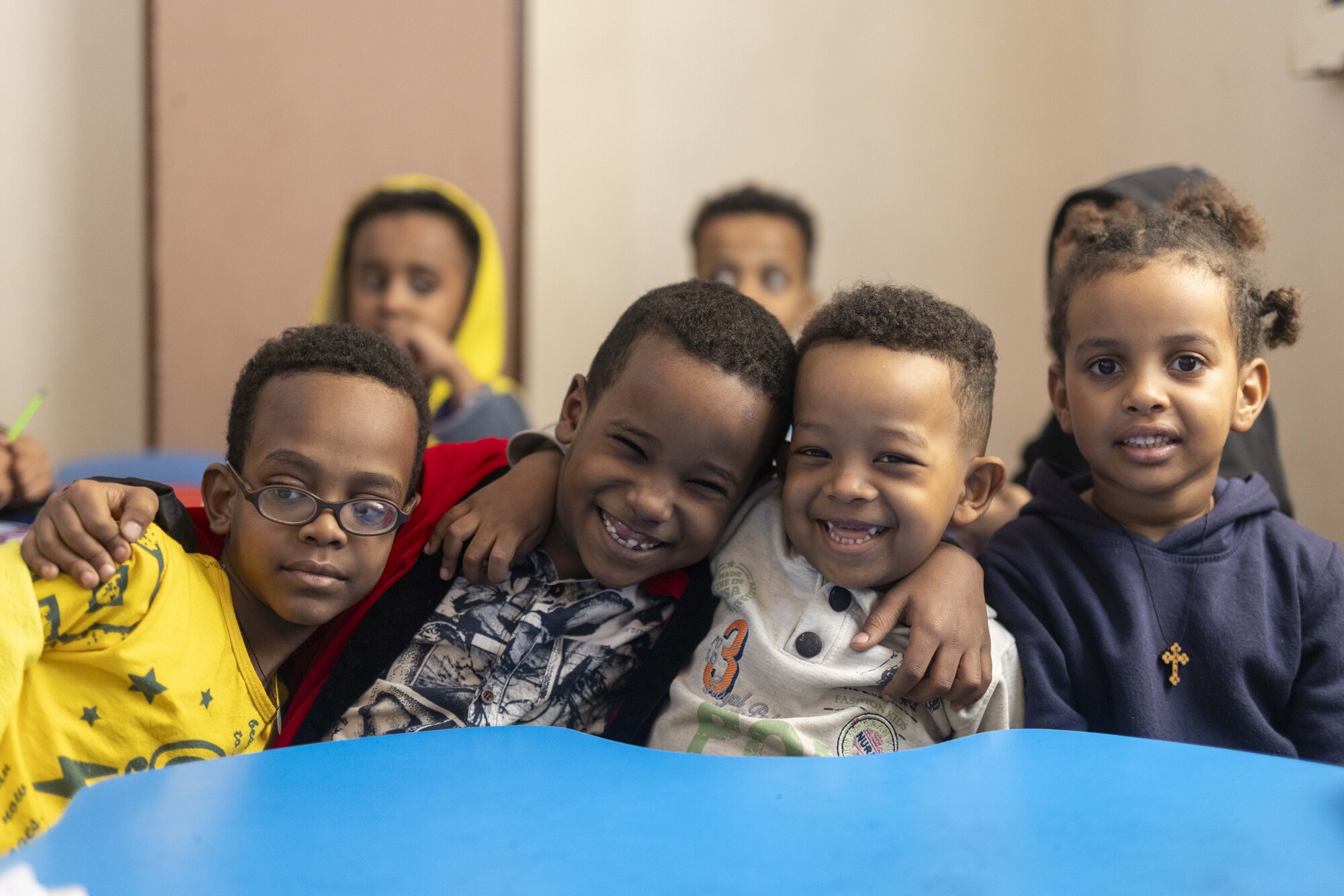 Group of boys sitting together with smiles.