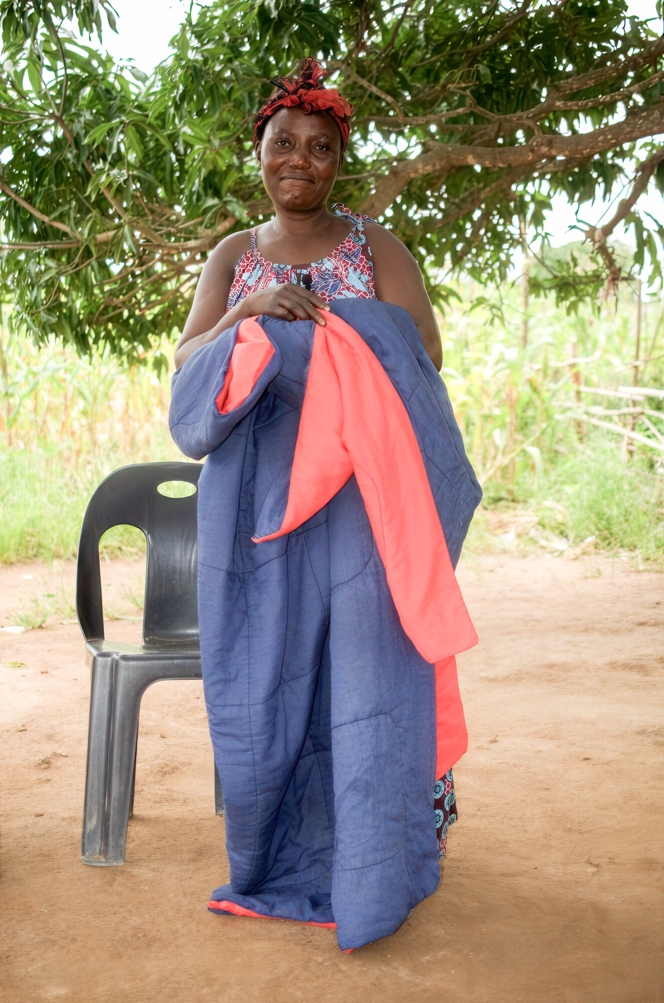 woman standing with comforter over her shoulders