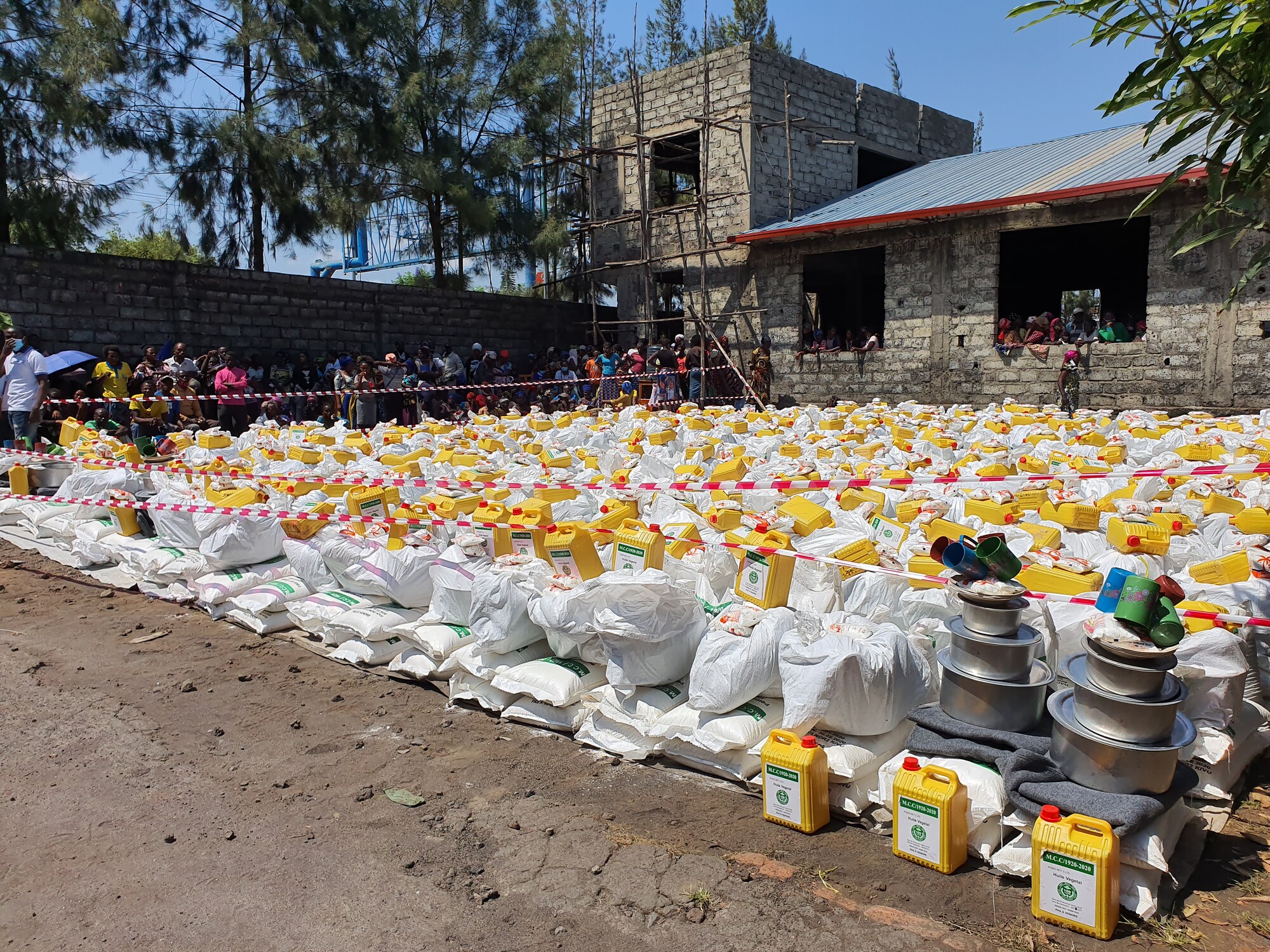 June 2021 distribution of emergency relief items, including maize flour, beans, vegetable oil, salt, blankets, pots, plates and cups, to families in the Buhene and Bugeregere communities in Goma, Demo