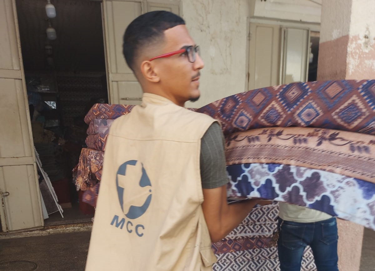 Man carries mattresses