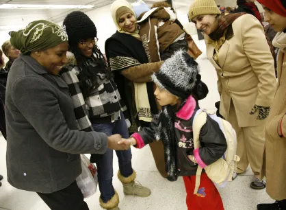 Family welcomes another family at the airport